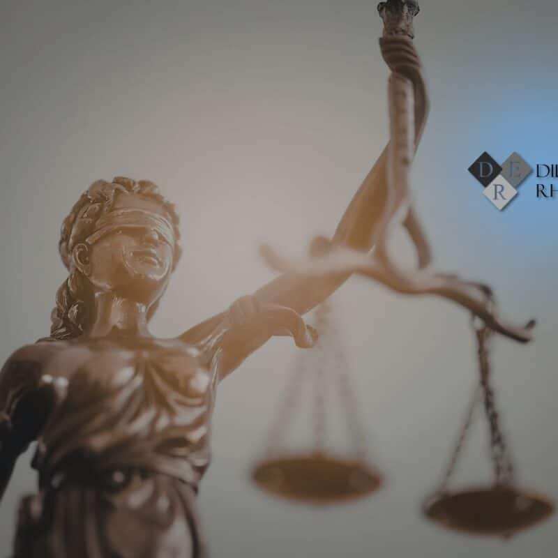 A bronze statue of Lady Justice with scales, representing the different types of litigation handled by a civil law firm.
