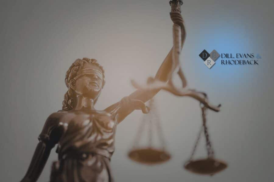 A bronze statue of Lady Justice with scales, representing the different types of litigation handled by a civil law firm.